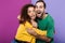 Portrait of joyous caucasian couple man and woman in colorful clothing rejoicing and hugging together