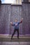 Portrait of jumping year eight year old boy in front of a city fountain waterfall