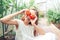 Portrait of kid with the big tomato in hands in greenhouse