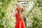 Portrait of kid with the big tomato in hands in greenhouse