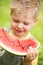 Portrait of a kid eating a slice of watermelon