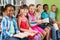 Portrait of kids reading book in library