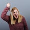 Portrait of killer woman with knife against gray background