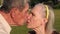 Portrait of kissing grandparents in the park.