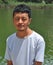 Portrait of a Ladakhi North Indian young guy looking at camera and standing beside of lake