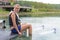 Portrait lady sat on jetty wearing water skis