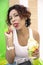 Portrait of a Latin American woman happily tasting an ice cream. Selective focus