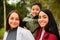 Portrait of Latin lesbian couple with their son in a park.