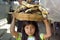 Portrait of Latino girl with bananas, child labor