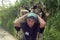 Portrait of Latino teen carrying firewood on head