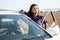 Portrait of latino woman standing near car