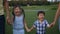 Portrait of laughing asian siblings walking in park