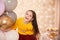 Portrait of laughing girl with balloons in beautifully room