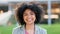 Portrait of laughing reporter with afro standing with a friendly facial expression before sharing news and broadcast