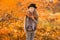 Portrait of a laughing young girl in the setting sun. Autumn portrait of a happy girl. Walk in the autumn park. Lifestyle