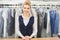 Portrait of a Laundry worker on the background of the clothing on hangers