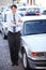 Portrait, lease and a man arms crossed at a dealership for car sale in a commercial parking lot. Business, rental and