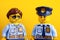 Portrait of Lego policeman and policewoman minifigures on yellow background