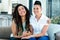 Portrait of lesbian couple sitting together on sofa and smiling