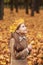 Portrait liitle cute girl with crown of leaves in autumn park