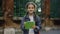 Portrait of lillte cute casual girl braids with schoolbag standing schoolyard smilling and writting notes outside