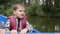 Portrait of little adorable child holds paddle. Close up view of little cute boy smiling at camera on lake. Happy child holds padd