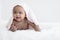 Portrait of Little African newborn baby girl smiling crawling on bed with towel on head to clean after bath. Innocent infant