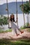 Portrait of little Asian girl playing the swing in the nature public park select focus