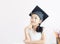 Portrait little Asian girl is wearing graduate hat and smile with happiness select focus shallow depth of field with copy space