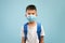 Portrait Of Little Asian Schoolboy Wearing Protective Medical Face Mask And Backpack