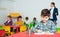 Portrait of little assiduous boy with pen and notebook at lesson in elementary school
