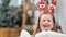 Portrait of little baby girl posing in funny Christmas ears laughing having positive emotion