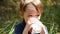 Portrait of a little boy. A happy child drinks milk or milk product from a glass. Proper and natural nutrition of