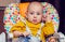 Portrait of a little boy in a highchair