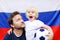 Portrait of little boy and his middle age father with russian flag on background