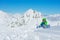 Portrait of a little boy lay in snow over mountain