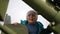 Portrait of little boy near military equipment in museum the park