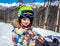 Portrait of little boy snowboarder in mountains