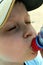 Portrait of a little boy wearing baseball cap drinking water