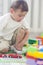 Portrait of Little Caucasian Boy Playing with Toys Indoors