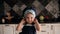 Portrait of a little charming girl of 3 years in a cap and apron in the kitchen.