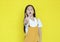 Portrait of little child girl showing two finger gesture as sign as fighting isolated over yellow background