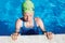 Portrait of little cute child in the swimming pool.