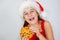 portrait little cute girl in santa hat eating christmas cookies