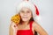 portrait little cute girl in santa hat eating christmas cookies