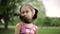 Portrait little girl is angry and disagrees crying in a summer park. Slow motion