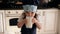 Portrait of a little girl in an apron and cap in the kitchen, she drinks kefir.