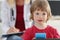 Portrait of little girl on background of doctor in white coat.