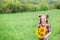 Portrait of little girl with big great gorgeous sunflower bouquet in her hands on the field background