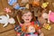 Portrait of little girl(child, kid) with dolls on the carpet